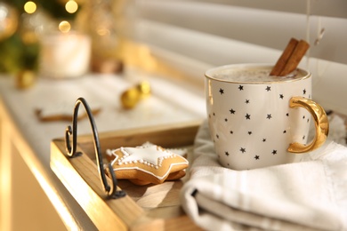 Composition with cup of hot drink on windowsill