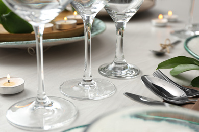 Photo of Clean glasses on decorated table. Festive setting