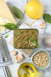 Photo of Flat lay composition with delicious pesto sauce and ingredients on white marble table