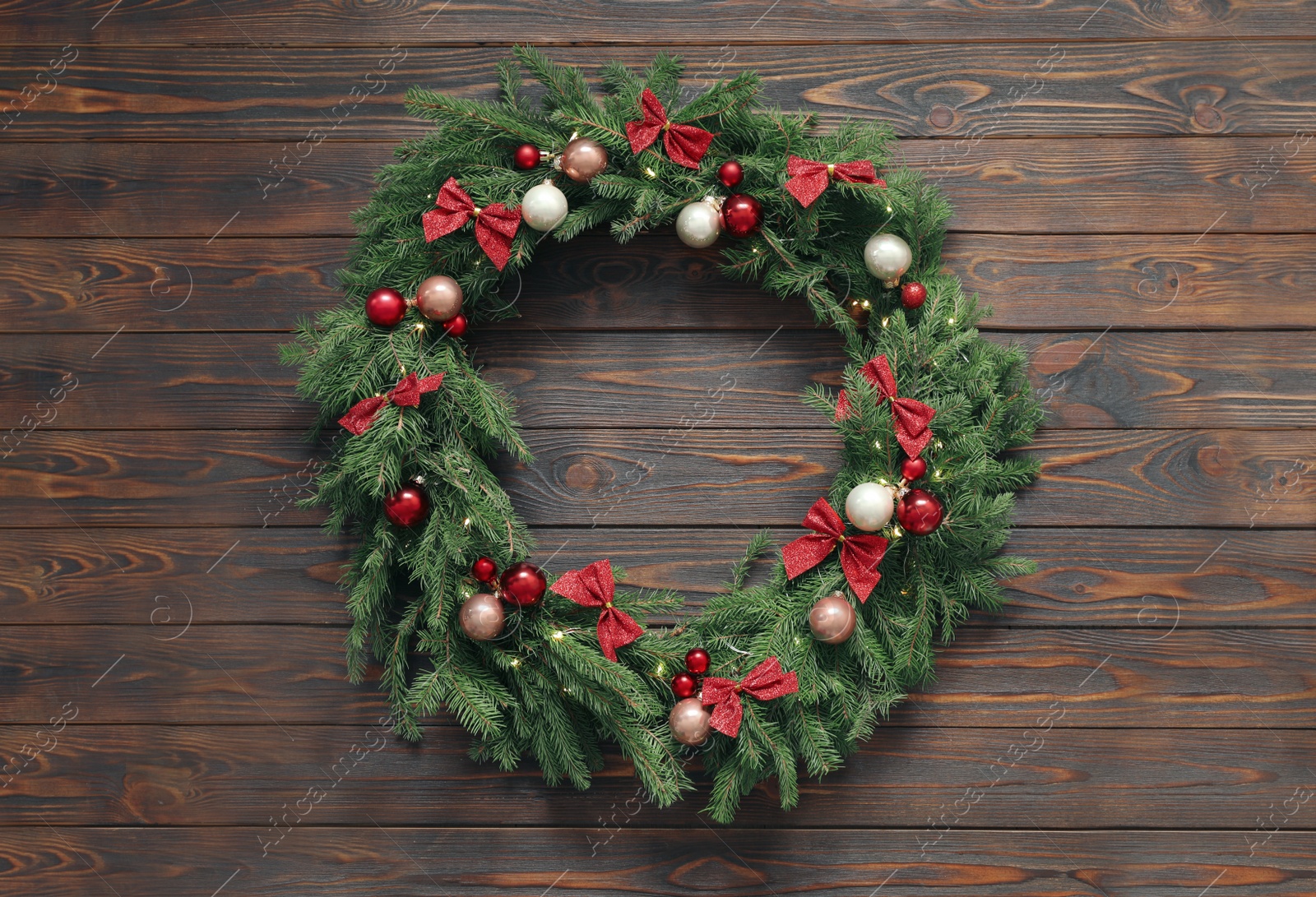 Photo of Beautiful Christmas wreath with festive decor on wooden background, top view