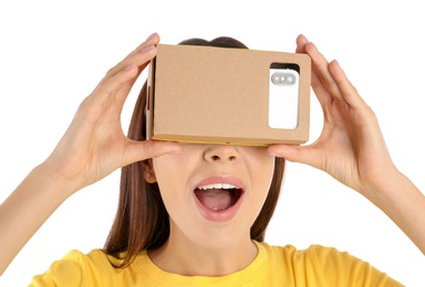 Young woman using cardboard virtual reality headset, isolated on white