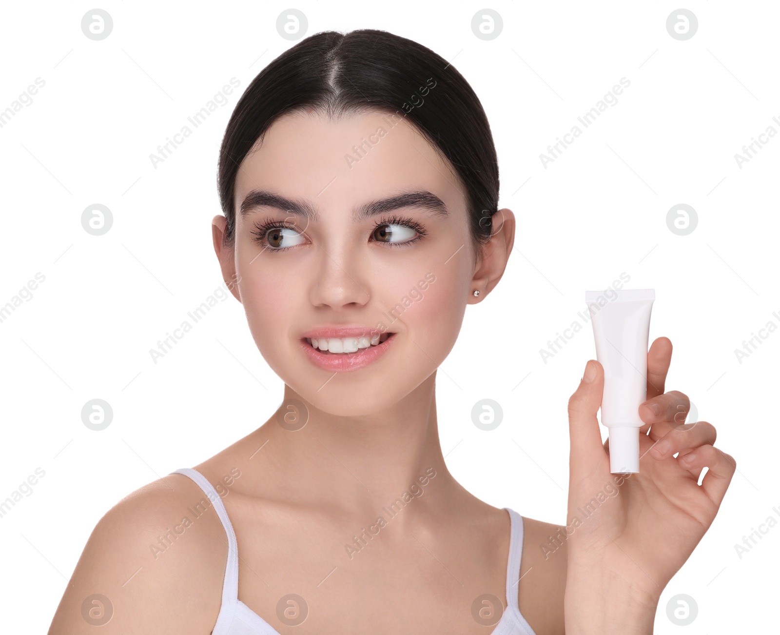 Photo of Teenage girl holding tube of foundation on white background