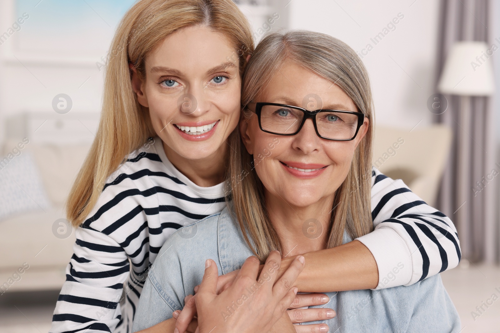 Photo of Happy mature mother and her daughter at home