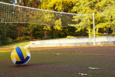 View of colorful ball on volleyball court outdoors