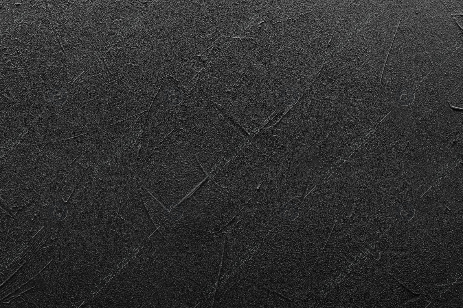 Photo of Black textured surface as background, top view