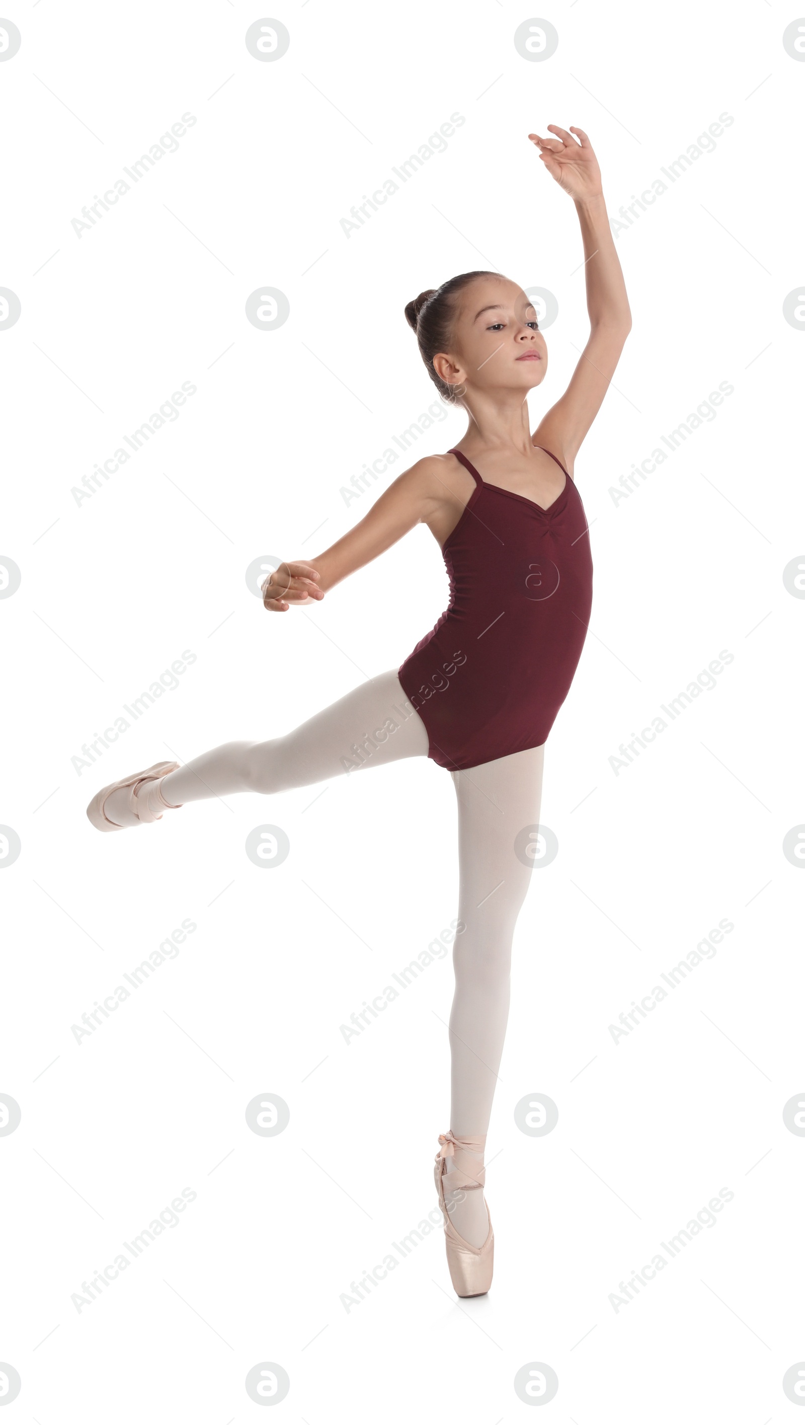 Photo of Little ballerina practicing dance moves on white background