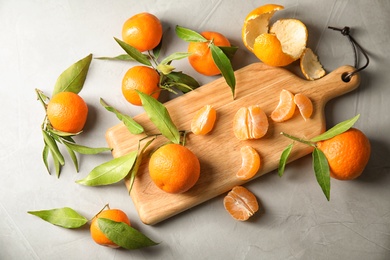 Photo of Flat lay composition with ripe tangerines on grey background