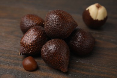 Photo of Fresh salak fruits on wooden table, closeup
