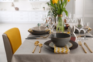 Photo of Beautiful Easter table setting with festive decor indoors