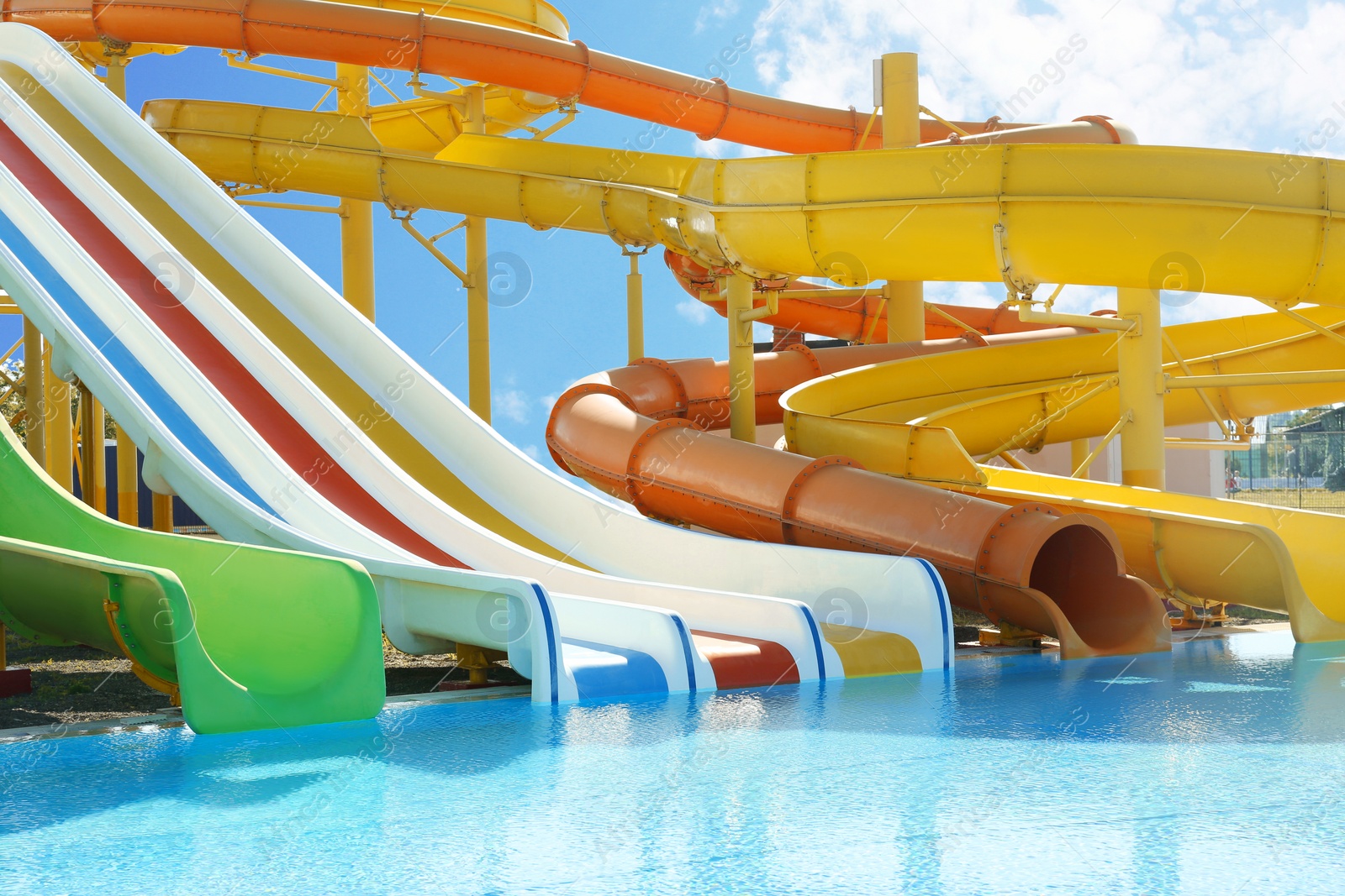 Photo of Different colorful slides in water park on sunny day