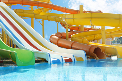 Photo of Different colorful slides in water park on sunny day