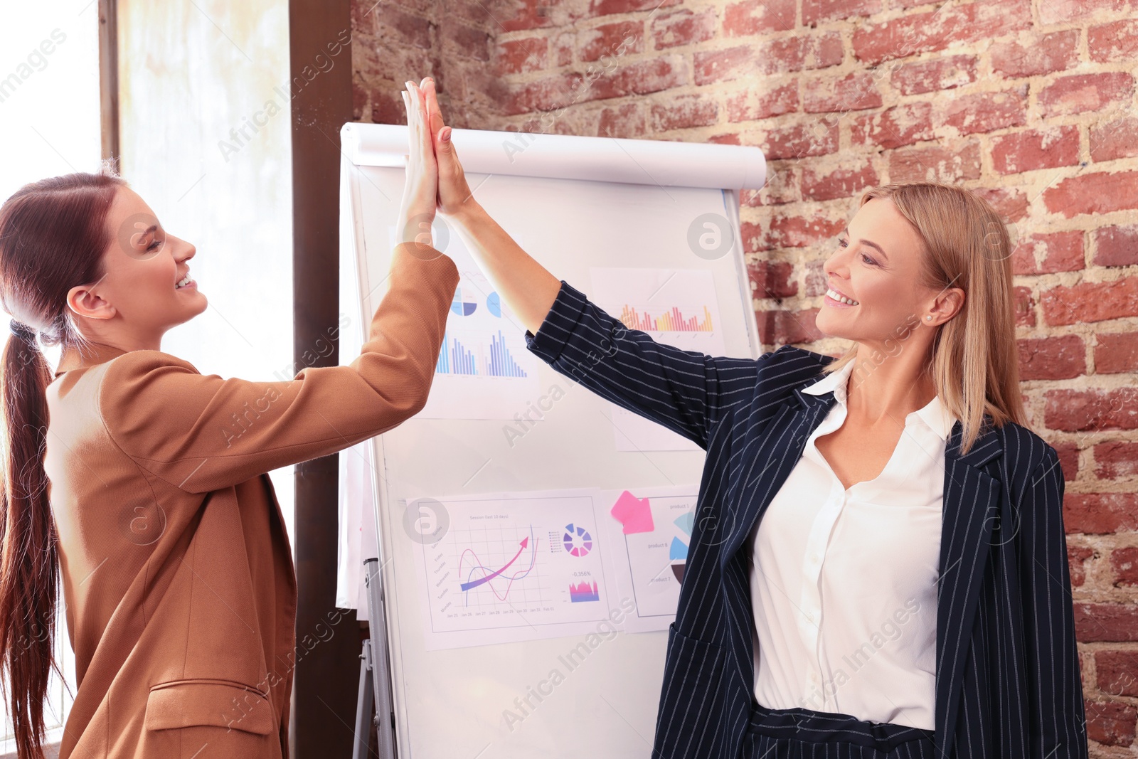 Photo of Businesswoman having meeting with her employee in office. Lady boss