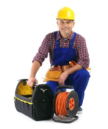 Photo of Electrician with extension cord reel and tools  wearing uniform on white background