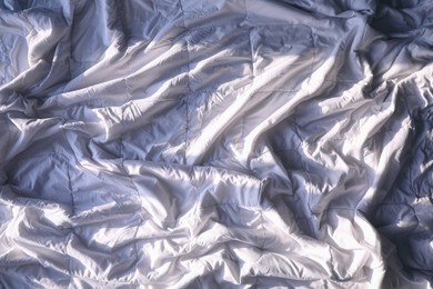 Photo of Soft white crumpled blanket as background, closeup
