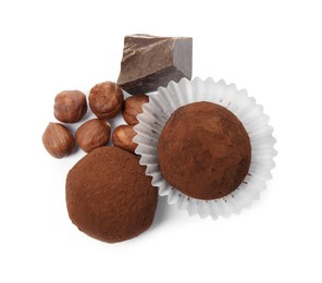 Photo of Delicious chocolate truffles with ingredients on white background, top view