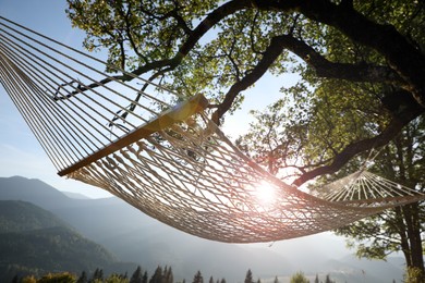 Comfortable net hammock in mountains on sunny day