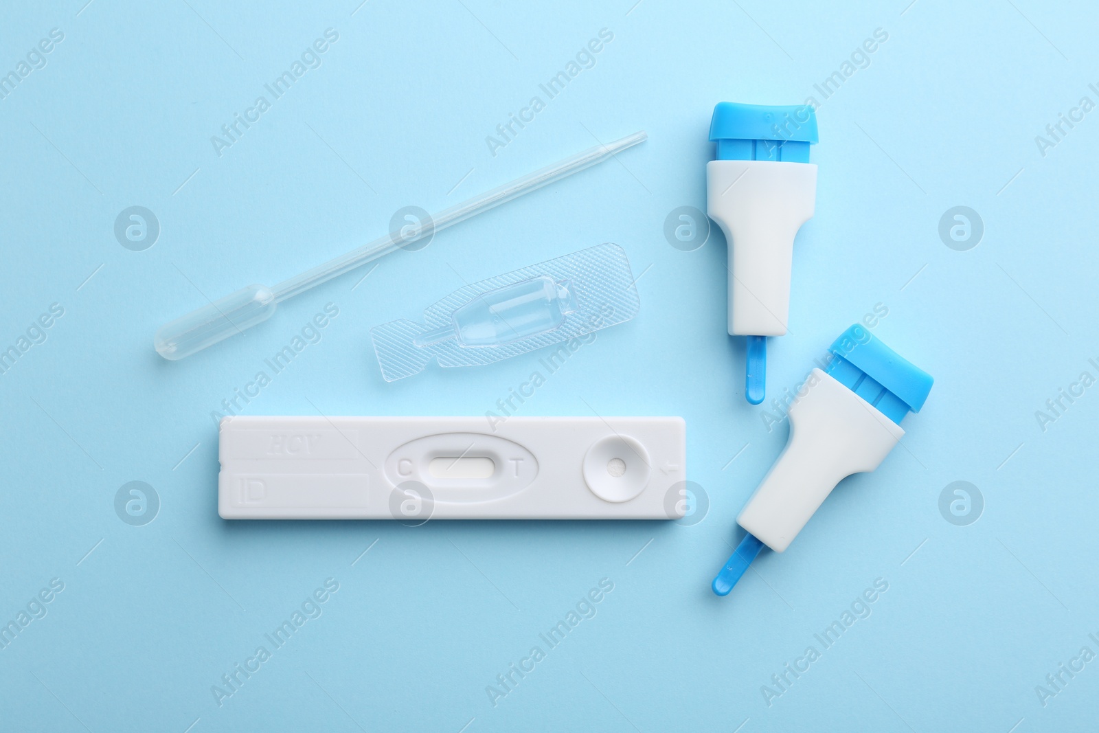 Photo of Disposable express test kit on light blue background, flat lay