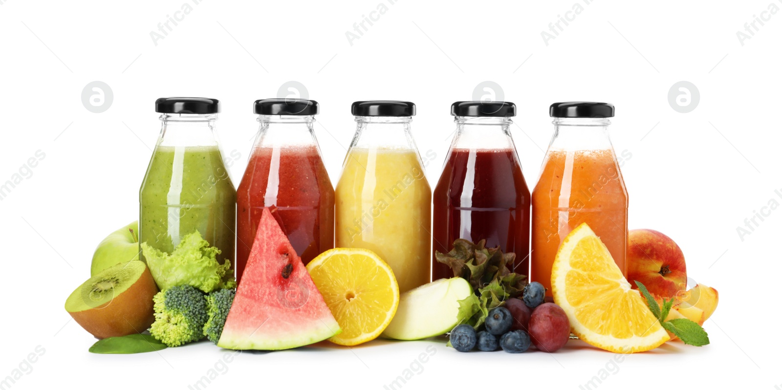 Photo of Bottles of delicious juices and fresh fruits on white background