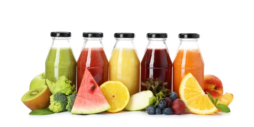 Photo of Bottles of delicious juices and fresh fruits on white background