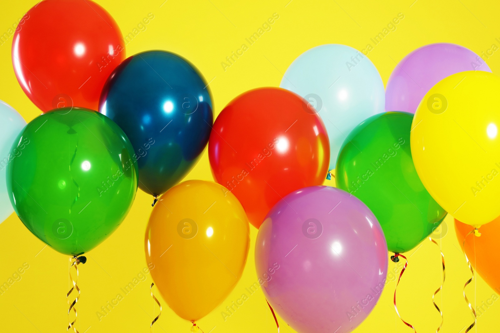 Photo of Bright balloons on color background. Celebration time