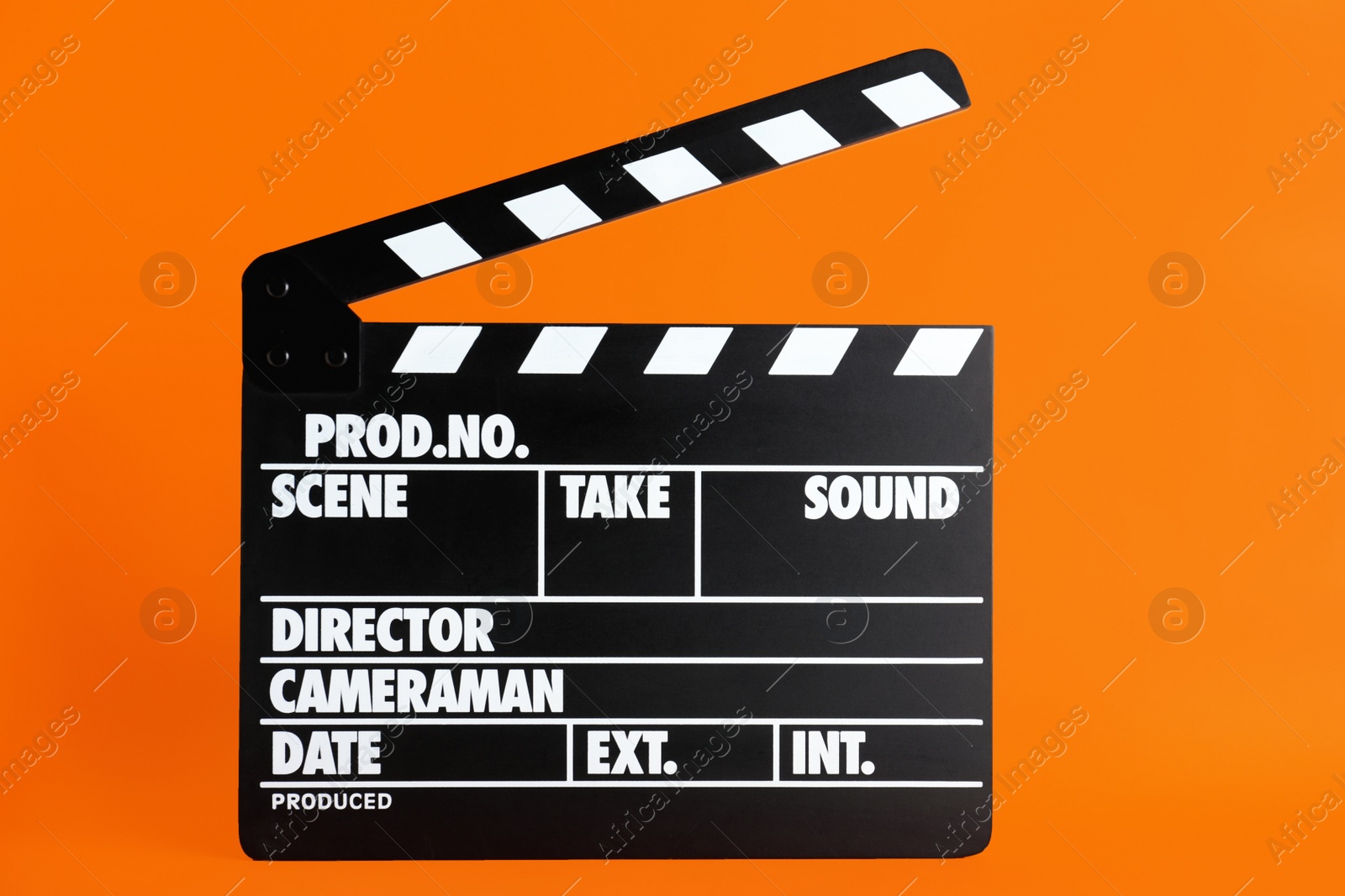 Photo of Clapper board on orange background. Cinema production