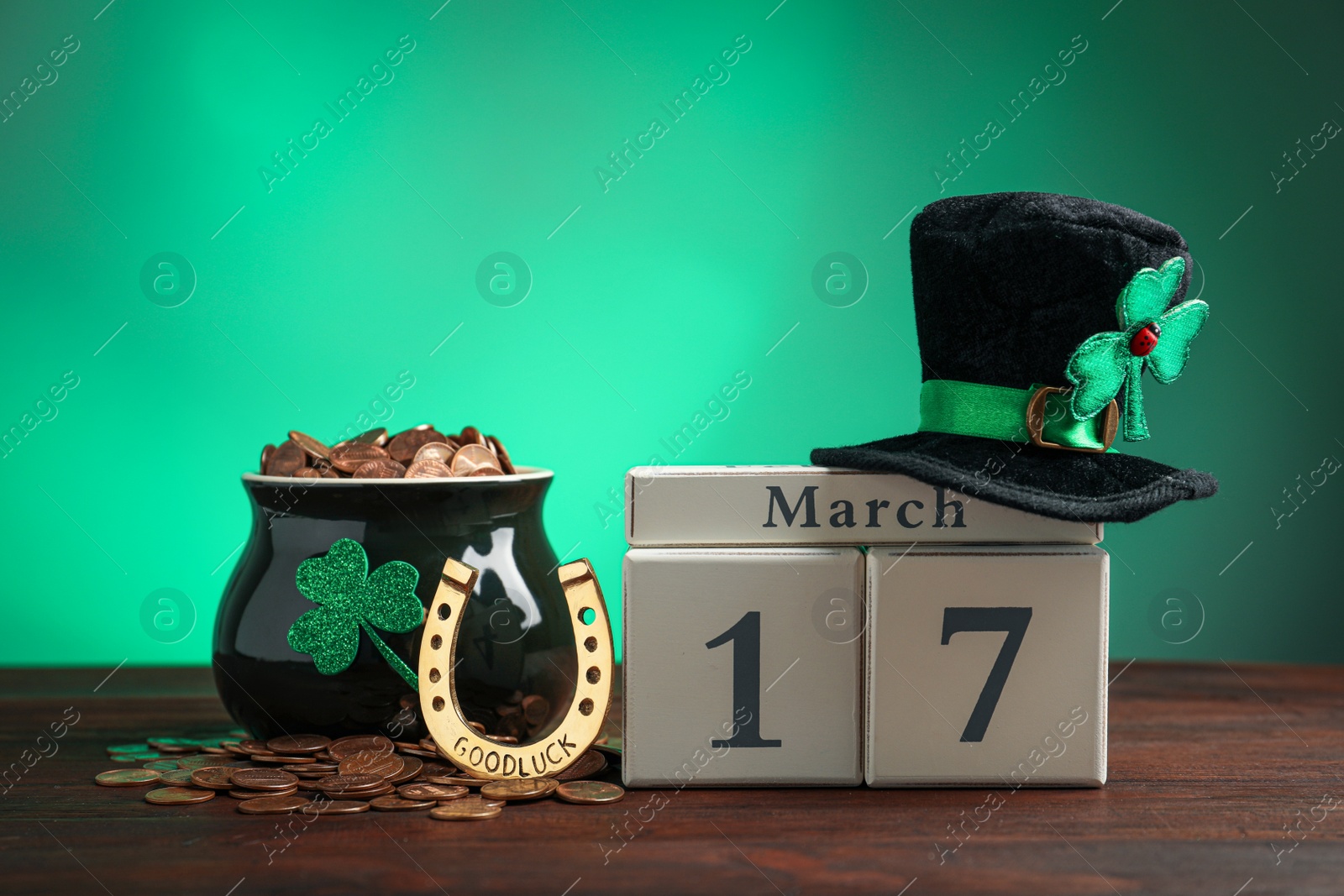 Photo of Composition with block calendar on wooden table. St. Patrick's Day celebration