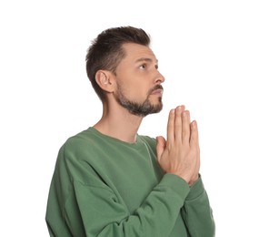 Photo of Man with clasped hands praying on white background
