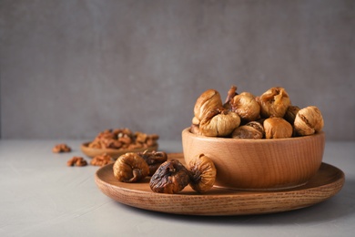 Photo of Composition with dried figs on grey table. Space for text