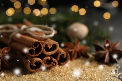 Different spices on table, closeup. Cinnamon, anise, brown sugar. Bokeh effect