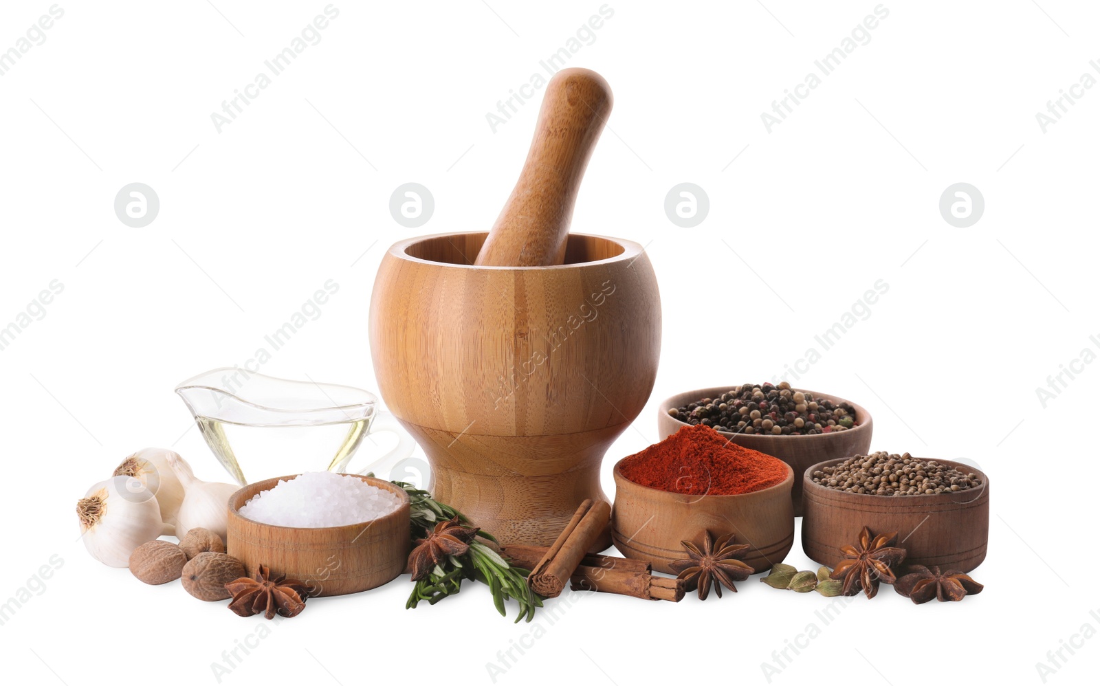 Photo of Mortar with pestle and different spices on white background