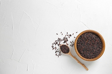 Flat lay composition with black rice and space for text on white background