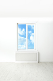 Image of Beautiful view on blue sky with clouds through window in room