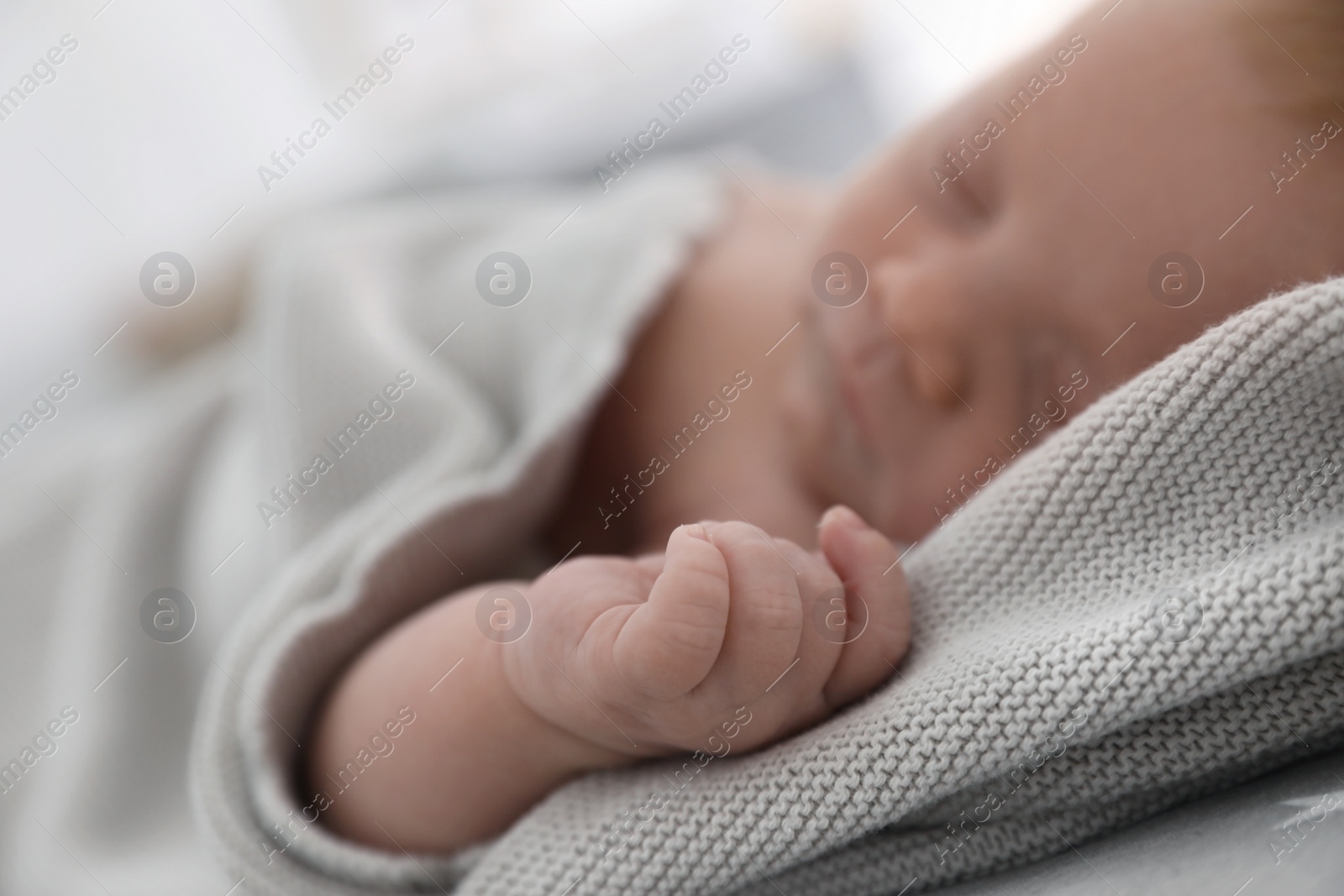 Photo of Cute little baby sleeping on bed, closeup