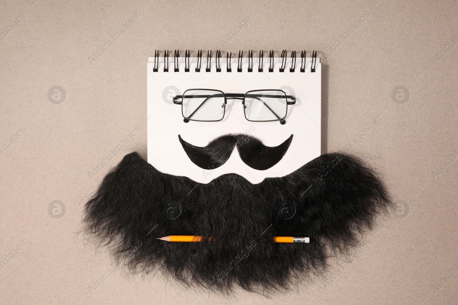 Photo of Flat lay composition with artificial moustache and glasses on light brown background