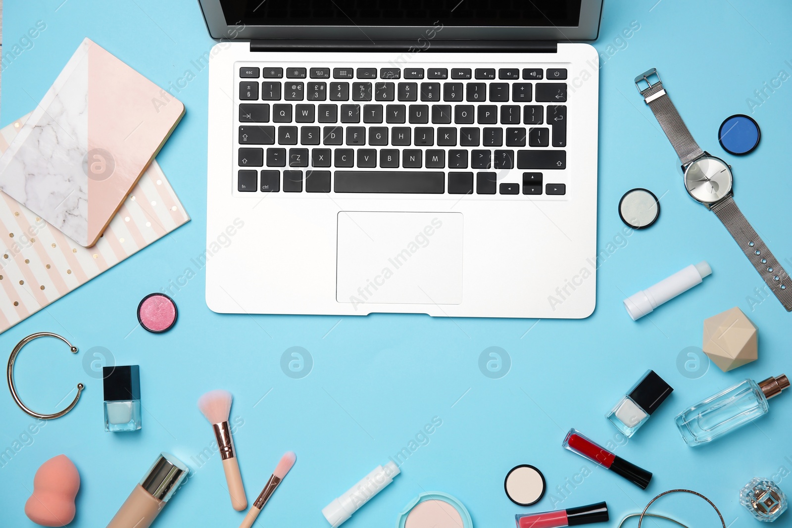 Photo of Flat lay composition with laptop and makeup products for woman on color background