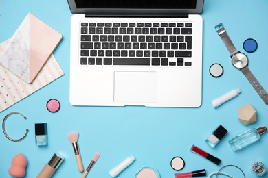 Photo of Flat lay composition with laptop and makeup products for woman on color background
