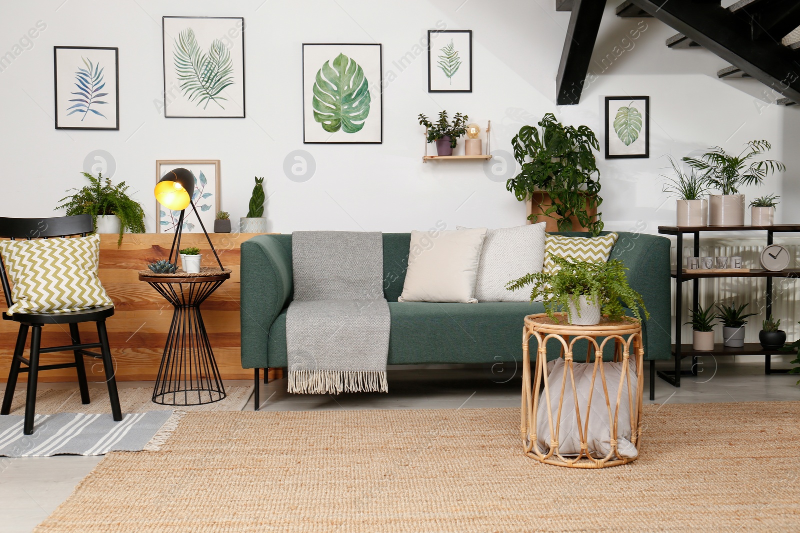 Photo of Stylish living room interior with comfortable sofa and green plants