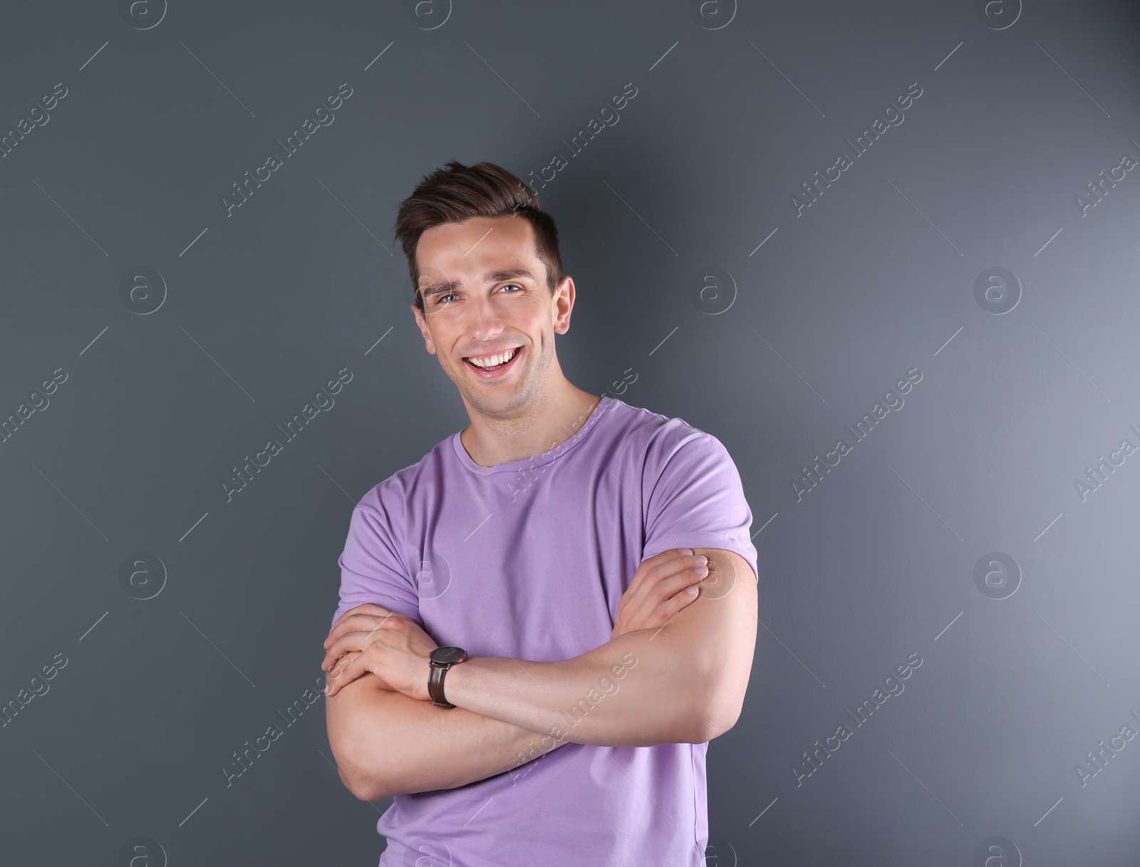 Photo of Handsome young man smiling on color background