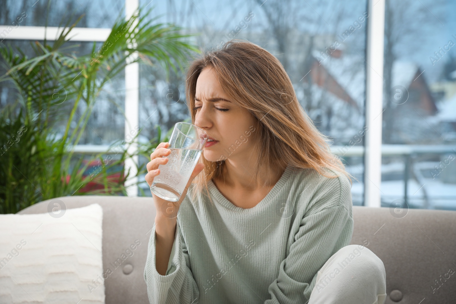 Photo of Woman taking medicine for hangover at home