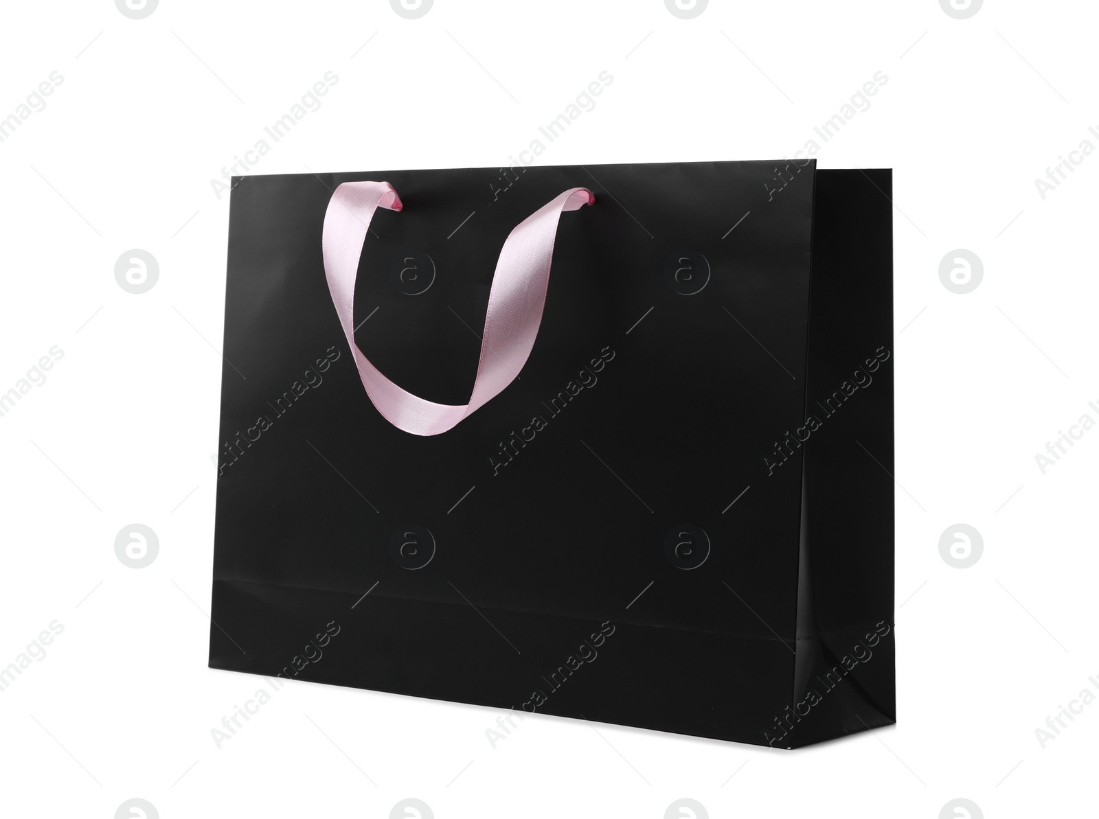 Photo of Paper shopping bag with ribbon handles on white background. Mockup for design