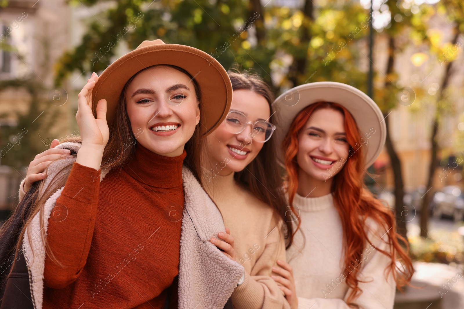 Photo of Portrait of happy friends spending time together outdoors