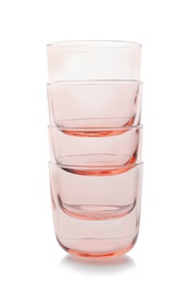 Photo of Stack of empty colorful whiskey glasses on white background