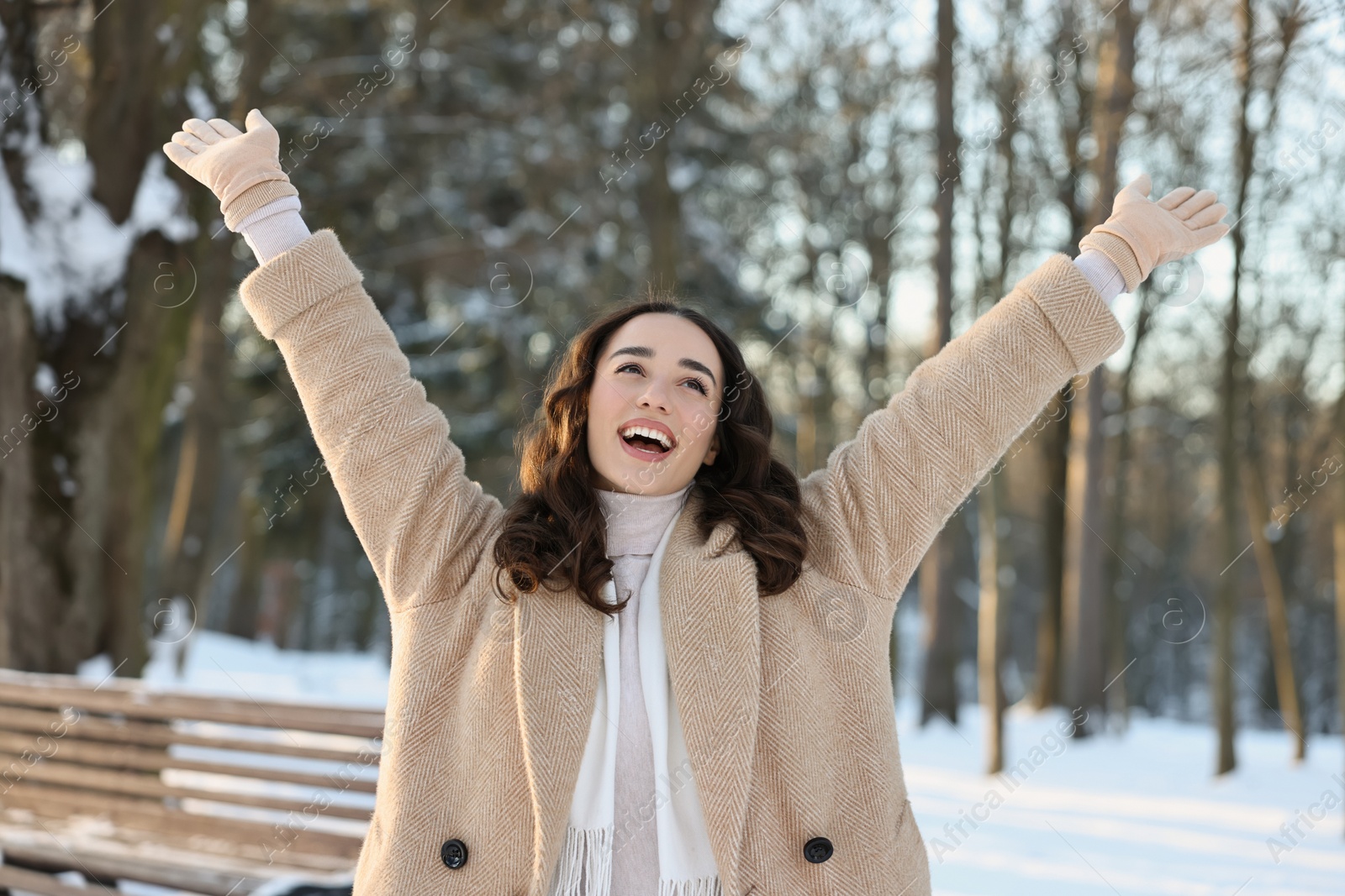 Photo of Portrait of happy woman having fun in snowy park