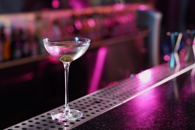 Photo of Fresh Martini cocktail on counter in bar. Space for text