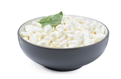 Fresh cottage cheese with basil in bowl isolated on white