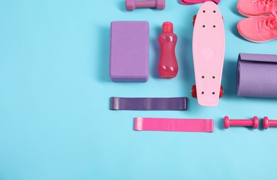 Photo of Different sports equipment on light blue background, flat lay. Space for text