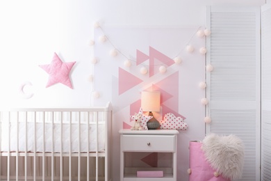 Photo of Baby bedroom interior with crib and beautiful decor elements