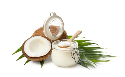 Photo of Jar with coconut oil and nuts on white background