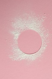 Frame made of rice loose face powder on pink background, top view. Space for text