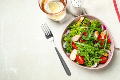 Delicious salad with chicken, arugula and tomatoes on grey table, flat lay. Space for text